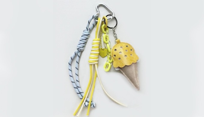 A playful ice cream-shaped charm keyring with a carabiner and strap, making it easy to attach to bag...