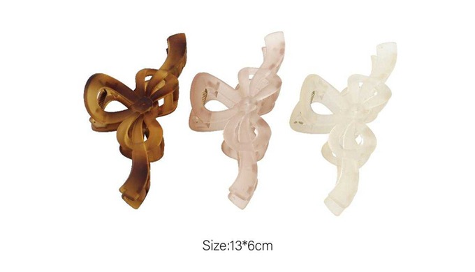 A set of hair claws featuring ribbon, butterfly, and flower designs, perfect for adding a stylish ac...