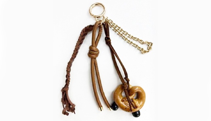 A charming keyring featuring bakery-inspired charms such as pretzel, croissant, and chocolate bar. P...