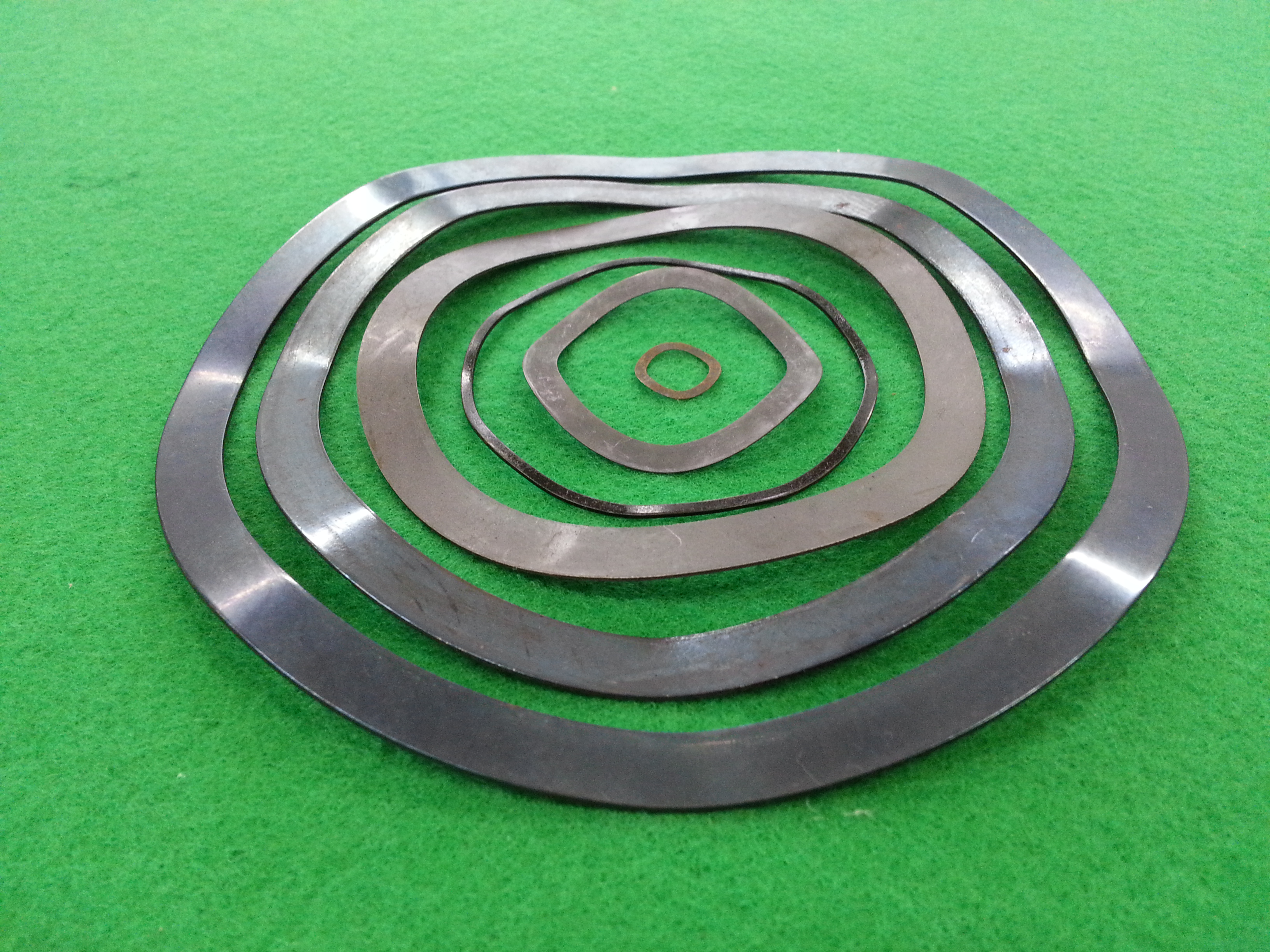 Wave spring It is a spring made out of pre-hardened flat wire in a process called, 'on-edge-coiling'