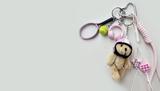 A cute bear doll keyring designed with a helmet, adding a playful and unique touch. Comes with a car...