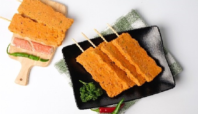 The premium steamed spicy seafood bar is a square shaped fish cake hot bar with seasoned squid, red ...