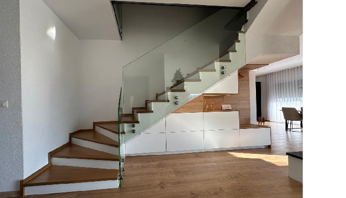 An entrance that reflects modern style and minimalist luxury. The staircase, defined by clean lines ...