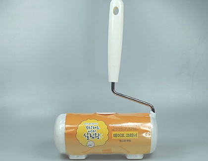 Adhesive roller paper tape cleaner