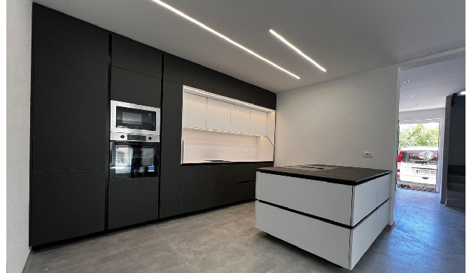 A modern kitchen designed with high standards of contemporary design, where minimalism, elegance, an...