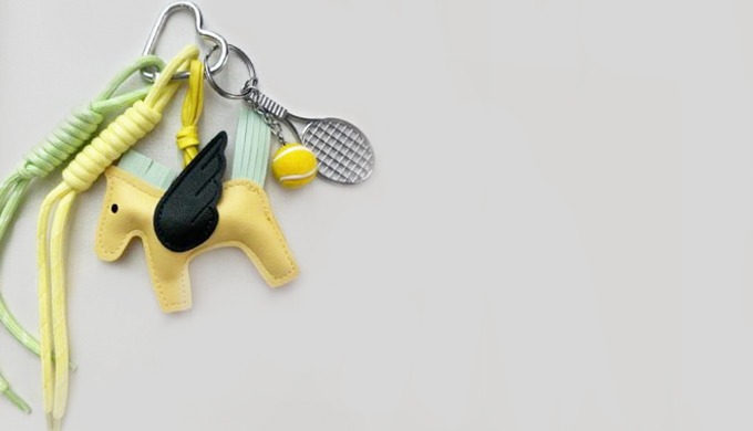 A cute and sporty Pegasus keyring featuring a mini tennis racket and ball charm. Made with soft leat...
