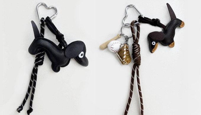 A playful keyring featuring a cute puppy charm combined with sports and accessory details. Perfect f...