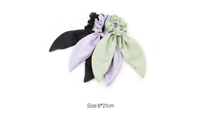 A scrunchie hair tie featuring a long, flowing ribbon accent. Made from soft materials to minimize h...