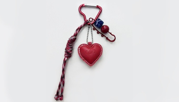A heart-shaped charm keyring with a carabiner and strap, perfect for attaching to bags or keys. Deco...