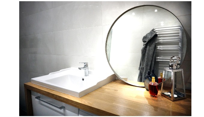 A tight wall mirror. The model has a stainless steel frame, great for bathrooms. Perfectly emphasize...