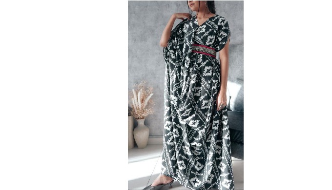 drape with Aztec print The modest dress is embellished with a belt and features a maxi length made o...
