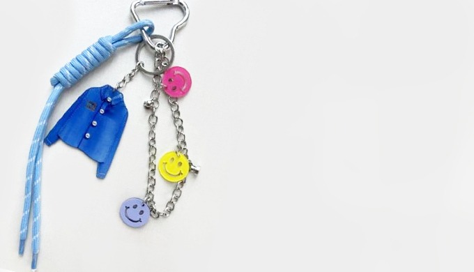 A unique keyring featuring fashion-inspired charms such as a shirt, shoe, and heart. Perfect for add...