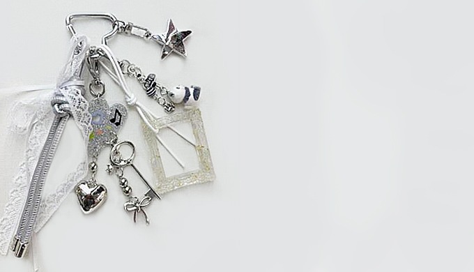 A unique keyring featuring mixed motifs such as stars, hearts, frames, puppies, and balloon dogs. Pe...