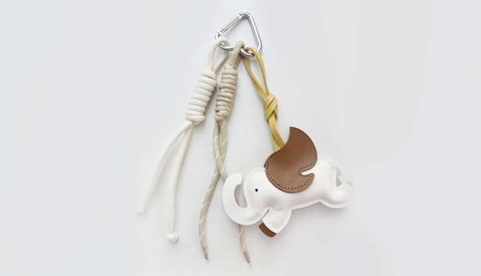 A cute elephant-shaped charm keyring with a carabiner and strap, making it easy to attach to bags or...