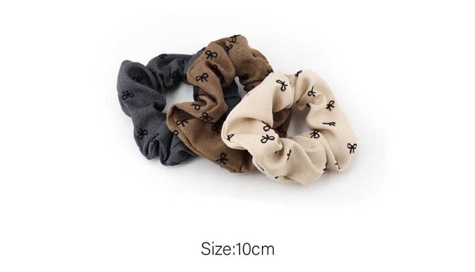 A collection of hair scrunchies in various patterns and designs, perfect for securing hair while add...