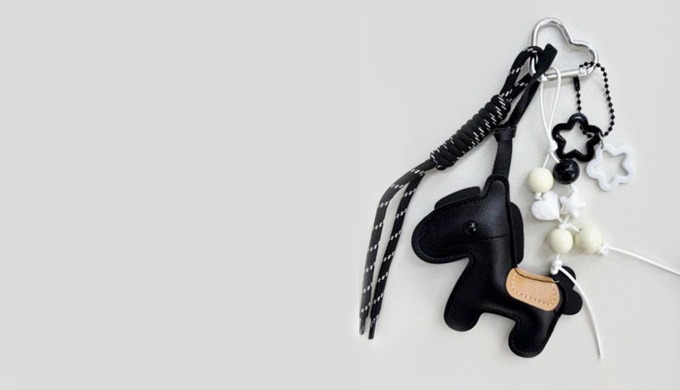 A horse-shaped charm keyring with a carabiner and strap, perfect for attaching to bags or keys. Acce...