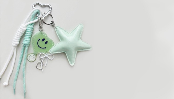 A stylish keyring featuring a 3D star charm with details like hearts, ribbons, and character accents...