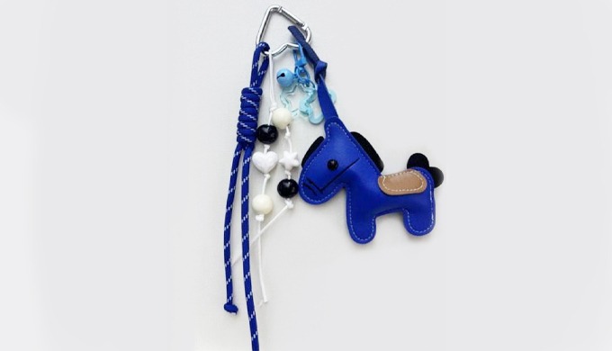 A horse-shaped charm keyring with a carabiner and strap, perfect for attaching to bags or keys. Deco...