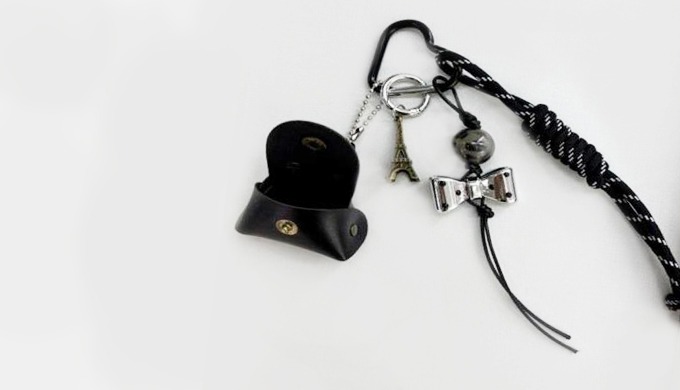 A keyring featuring leather mini pouch, owl, ribbon, Eiffel Tower, and other charms. Its classic yet...