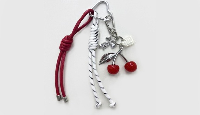 A stylish keyring featuring a lovely cherry charm with decorative details. Perfect for adding a fun ...