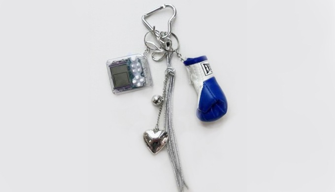 A mix keyring featuring a combination of unique charms such as hearts, leather mini bags, and digita...